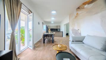 Apartment, 2 Bedrooms, Sea View | Living area | 65-inch Smart TV with digital channels, heated floors