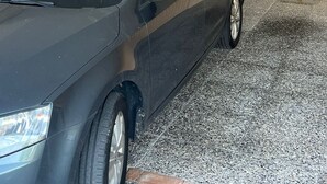 A car parked inside a garage with a ladder and a fire extinguisher on the wall. - Marenco apartment in Stresa with lake view (Stresa)