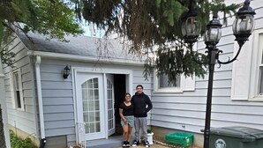 A residential house with a front door, a porch, and a green trash bin. - Uniquely remodeled 3 bdrm 1 bth home in safe area! Fenced in with a large deck!  (Owensboro)