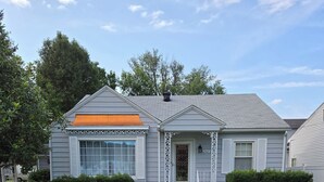 A single-story house with a front porch, a mailbox, and a number '907' on the door. - Uniquely remodeled 3 bdrm 1 bth home in safe area! Fenced in with a large deck!  (Owensboro)