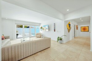 A modern interior with a reception desk, seating area, and artwork on the walls.
