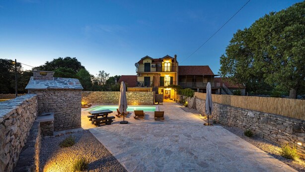 A two-story house with a stone exterior, a swimming pool, and outdoor seating. - Cozy home in Mirlovic Zagora (Mirlovic Zagora)
