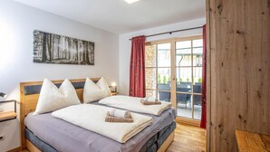 A double bed with a headboard, a bedside table, a nightstand, a window with a view of the outside, and a painting on the wall. - Pet friendly apartment (Rußbach am Pass Gschütt)