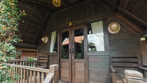 A wooden cabin with a porch, wooden doors, and a number '2' sign. - Sandat Bali Villa (Canggu)