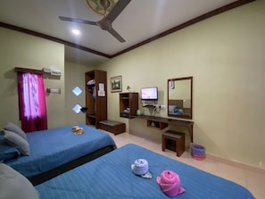 A hotel room with two beds, a desk, a television, a mirror, and a ceiling fan. - Chalet TM3 Langkawi (Langkawi)