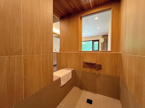A bathroom with wooden paneling, a window, a towel, and a sink. - HOTEL KANWOLGE (Ulsan)