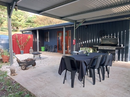 Outdoor dining. Private cottage on 40 acres with private creek and spectacular views.