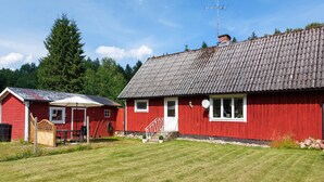 A red wooden house with a grey tiled roof, a small porch, and a satellite dish. - Awesome home in Vittsjö with WiFi (Vittsjö)