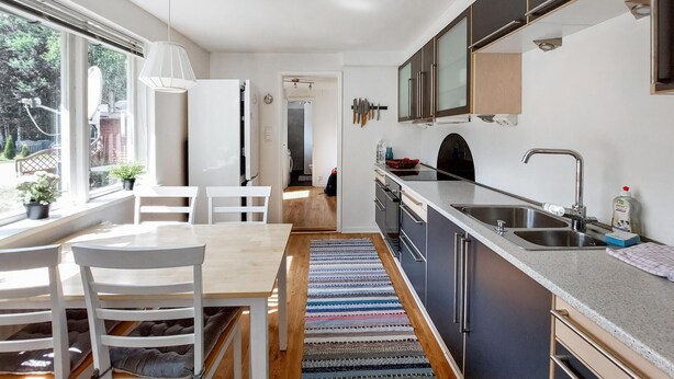A modern kitchen with a large window, a dining area with a table and chairs, and a view of the outdoors. - Awesome home in Vittsjö with WiFi (Vittsjö)