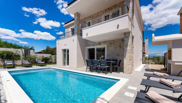 A modern two-story building with a swimming pool, outdoor seating, and a view of the landscape. - Villa Casa Coral with pool (Crno)