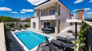 A two-story house with a swimming pool, outdoor seating, and a view of the landscape. - Villa Casa Coral with pool (Crno)