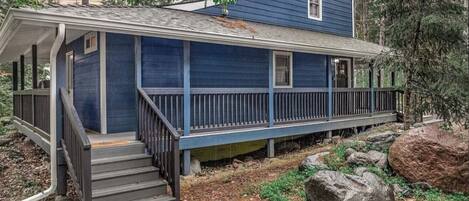 A two-story house with a porch and a covered front porch area.