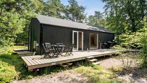 A small cabin with a deck, outdoor seating, and a grill area. - 3 bedroom amazing home in Stege (Stege)
