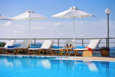 Seasonal outdoor pool, open 8:00 AM to 8:00 PM, pool umbrellas