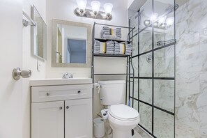 Shower, hair dryer, towels, shampoo