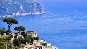 A coastal town with buildings on a hillside overlooking the sea.