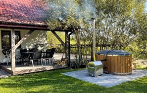A patio with outdoor furniture, a grill, and a hot tub. - 2 bedroom awesome home in Szarejki (Szarejki)