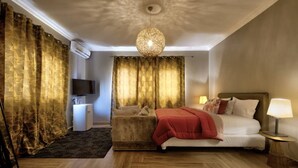 Ein Hotelzimmer mit Bett, Fernseher, kleinem Schreibtisch und Lampe.