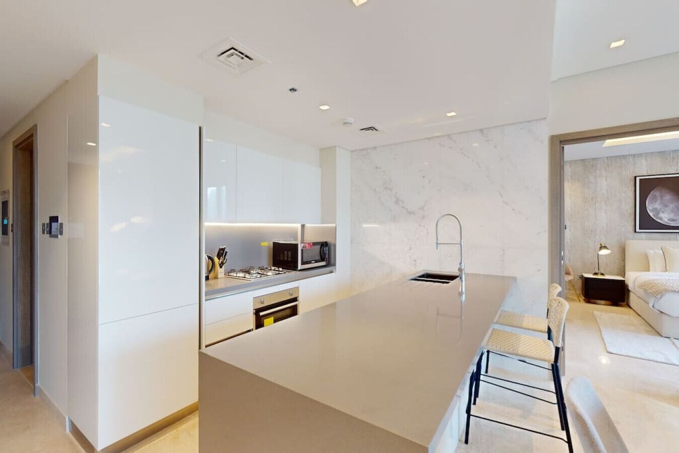 A modern kitchen with a central island, built-in appliances, and a minimalist design.