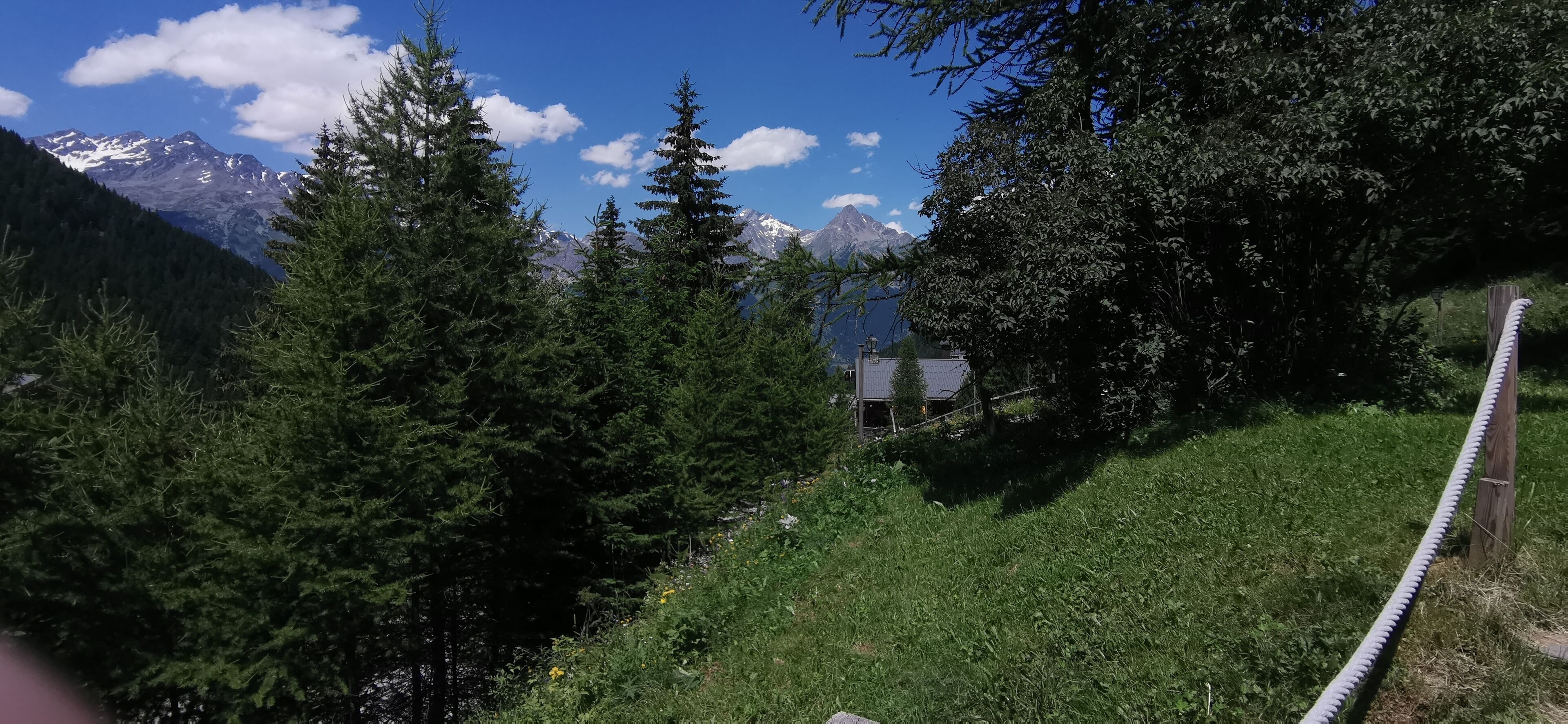 A mountainous landscape with dense forests and a clear sky.