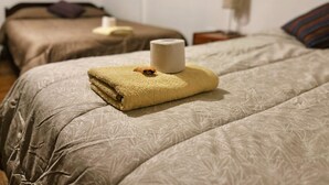 A hotel room with two beds, each with a different textured bedspread. - Casa Suecia  (Cusco)