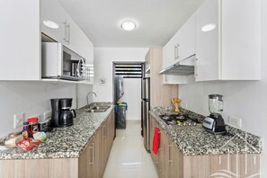 Fridge, microwave, stovetop, coffee/tea maker