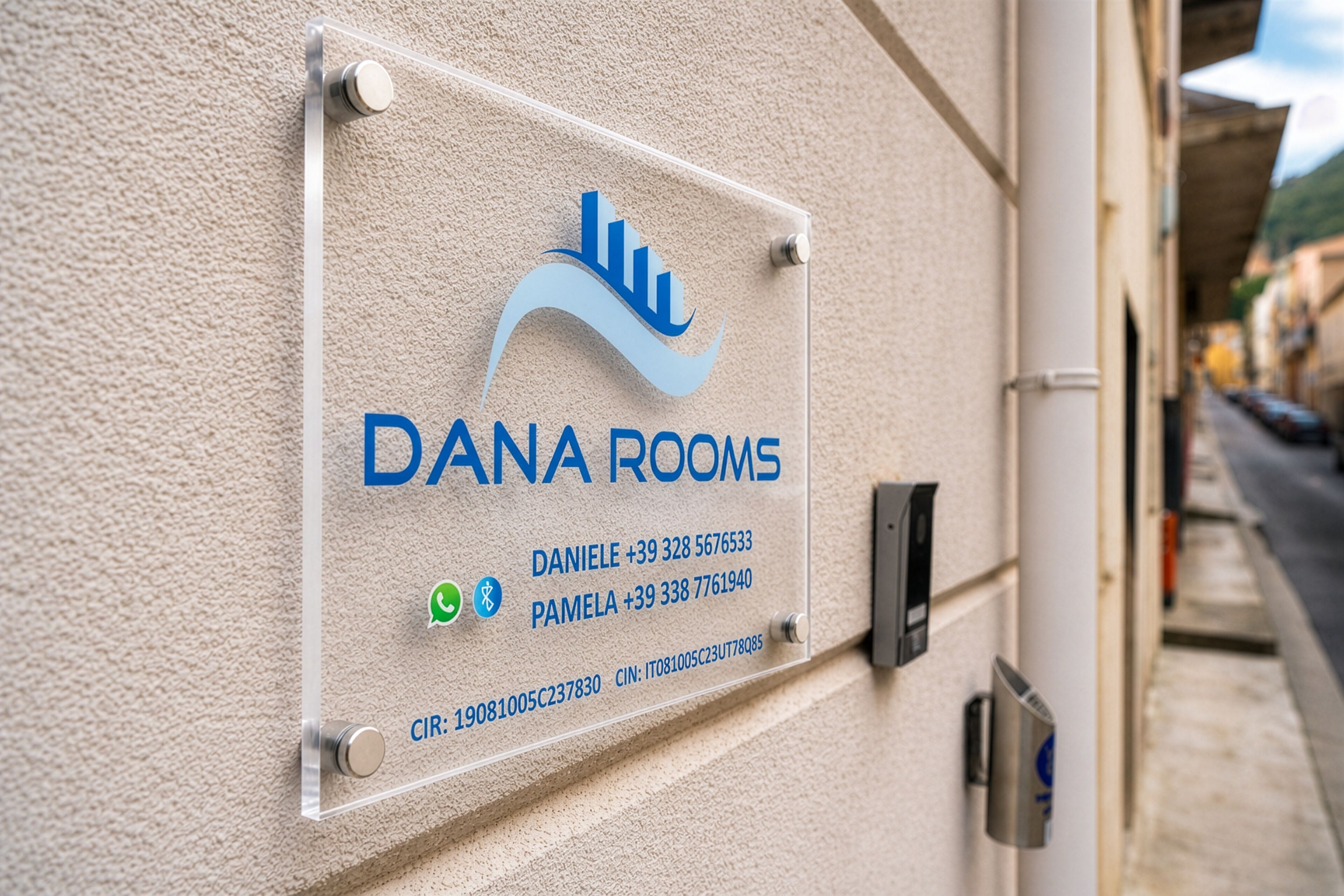A sign for Dana Rooms with contact information and a QR code.