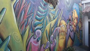 A colorful mural with abstract shapes and figures on a wall.