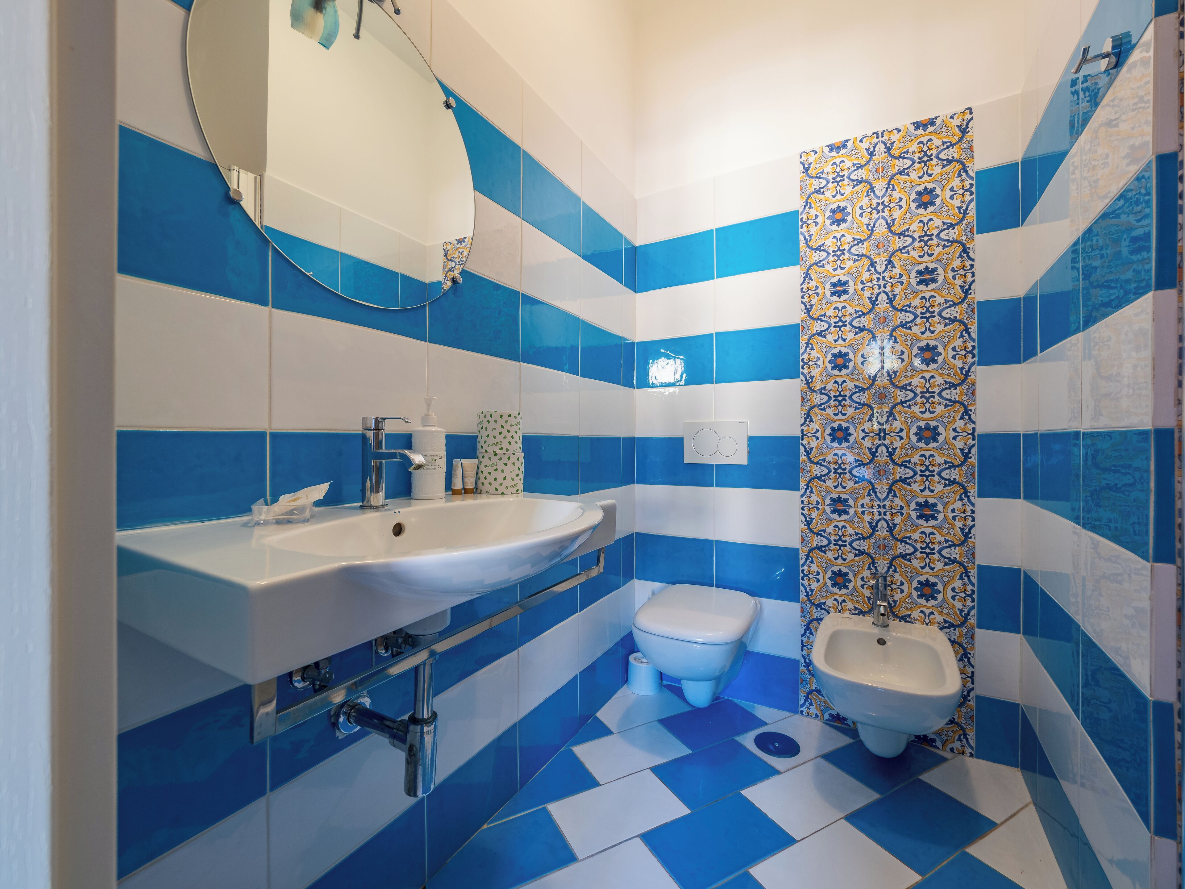 A bathroom with a white sink, a toilet, and a shower area.
