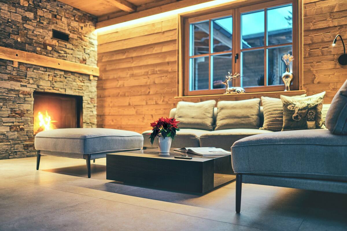 A cozy living room with a fireplace, a sofa, and a coffee table.