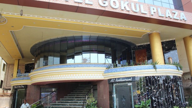 The exterior of Hotel Gokul Plaza with a prominent entrance, a staircase, and an adjacent AC Restaurant. - Gokul Plaza (Bhubaneshwar)