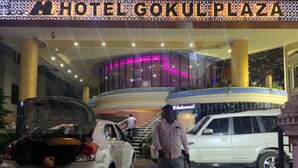 A hotel entrance with a large, circular, multi-level atrium and a visible restaurant sign. - Gokul Plaza (Bhubaneshwar)