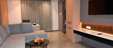 Luxury Suite, City View | Living area | 32-inch LED TV with cable channels