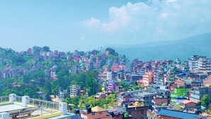 A densely packed urban area with numerous multi-story buildings, some with visible balconies. - SS Hotel Kings & Lodge Charikot Dolakha (Bhimeshwar)
