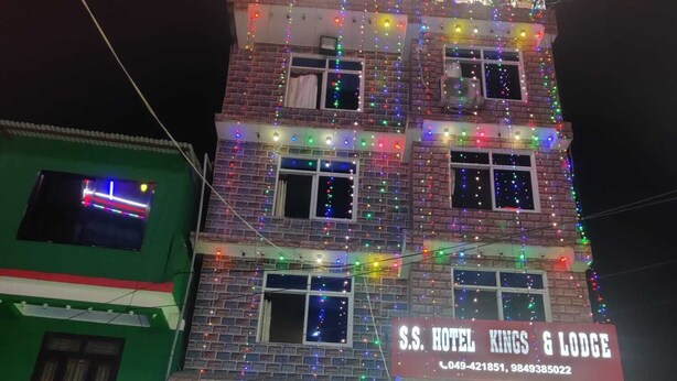 A multi-story building with a sign for "S.S. HOTEL KINGS & LODGE" and contact numbers. - SS Hotel Kings & Lodge Charikot Dolakha (Bhimeshwar)
