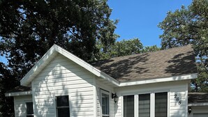 A single-story house with a front porch, a small garden, and a mailbox. - Cozy 2-bd home in Newfolden. WiFi, AC, Full kitchen & living room w fireplace!  (Newfolden)