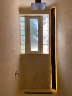 Enjoy a serene view from this cozy space with a single window offering a glimpse of the outside.