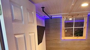 A bedroom with a bed, a window, and a door. - #5 getaway cabin 
 (New Lexington)