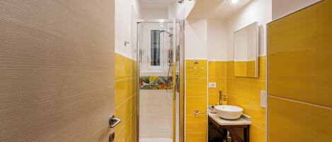 A modern bathroom with a shower, toilet, and sink.