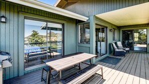 A deck with a table and chairs, large sliding glass doors, and a view of the outdoors. - 5BR Group Escape • Game Room • Views • Sleeps 12 • 10 mins to DT • EV charger (Prescott)