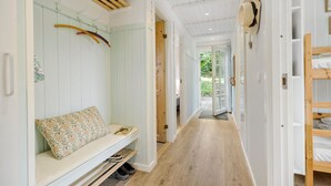 A narrow hallway with a bench, wooden flooring, and a bunk bed on the right. - Amazing home in Ebeltoft with WiFi (Ebeltoft)