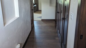 A hallway with wooden flooring, white walls, and a window on the left. - Appleton Country home with AC and Wifi (Appleton)