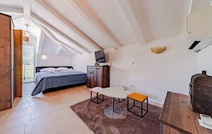 A bedroom with a bed, a desk, a chair, and a television. - Stunning home in Ston (Ston)
