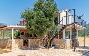 A two-story stone house with a covered patio, a staircase, and a balcony. - Stunning home in Ston (Ston)