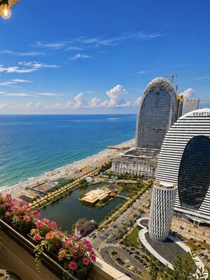A coastal hotel with a modern design, featuring a prominent curved building and a circular structure. - Orbi City Sea View (Batumi)