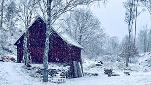 A snow-covered barn in a rural setting with bare trees and a snowy landscape. - 2 bedroom gorgeous home in Hallaryd (Hallaryd)