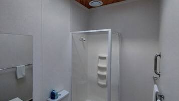 A modern bathroom with a shower, toilet, and sink.