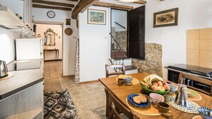 A rustic kitchen with a wooden table set for breakfast, featuring fruits, pastries, and a coffee pot. - 2 bedroom pet friendly home in Todi (Todi)