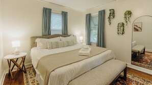 A neatly arranged bedroom with a bed, bedside tables, a bench, and a mirror. - Historic Revival King Bed Liberty Bowl Memphis 895 (Memphis)