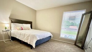 A bedroom with a bed, bedside table, lamp, and a window with blinds. - Worker friendly, cozy, great location, quiet, full kitchen, WiFi,  (Sherman)
